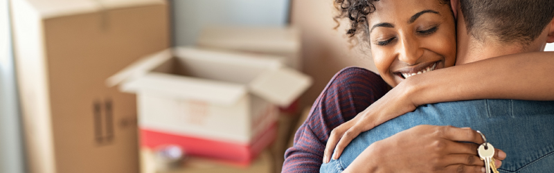Couple hugging in first home