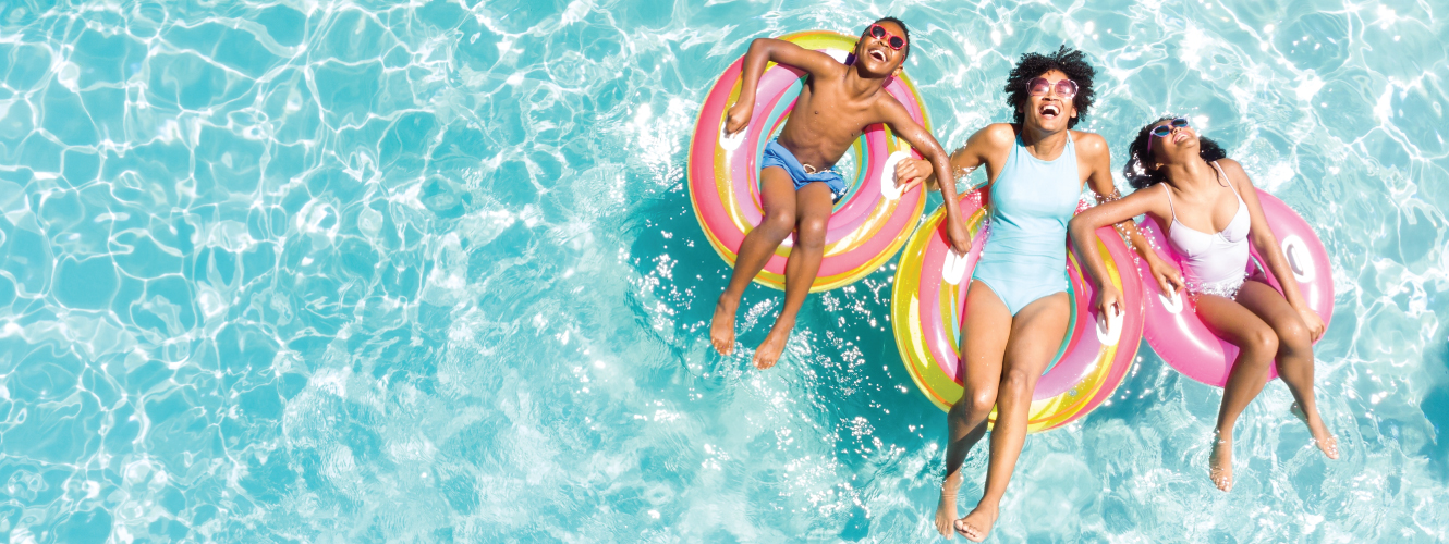 people enjoying the pool on floaties